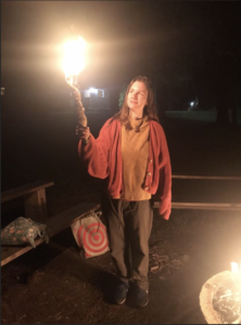 a person holds a lit homemade candle